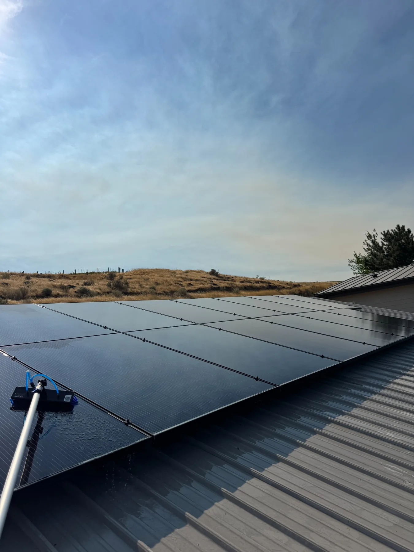 Solar panel cleaning on a metal roof in the Tri-Cities Washington